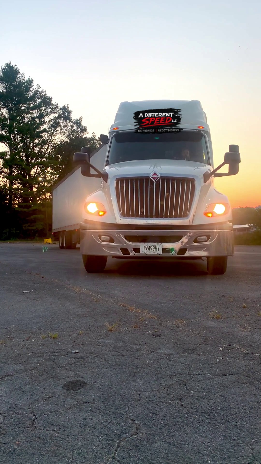 International tractor pulling a dry van at sunrise
